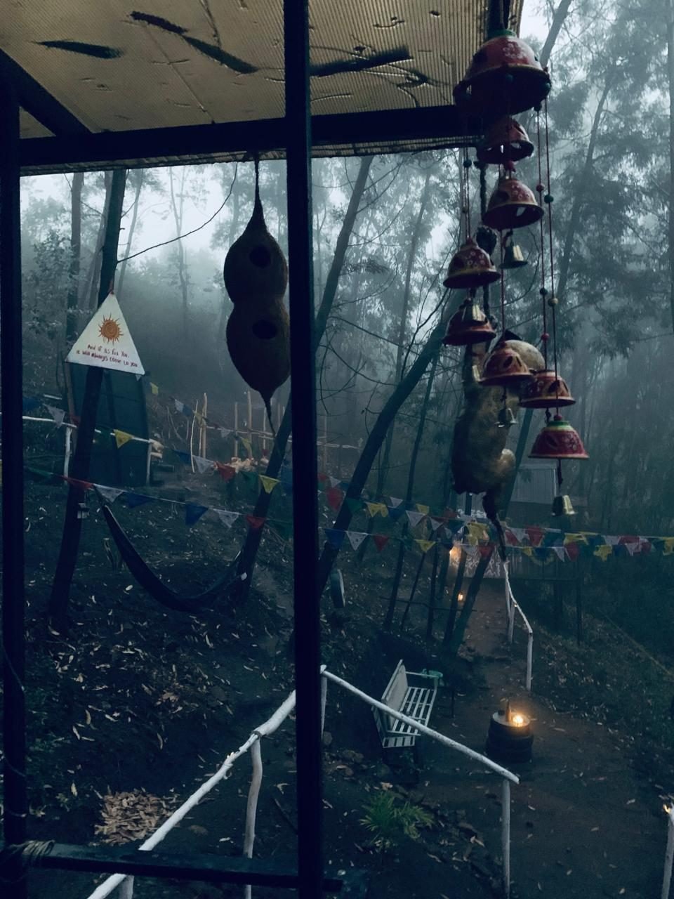 Mowgli Camp deck view with prayer flags and mist